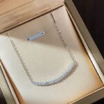 Bella Moissanite Necklace with curved bar and round stones on gold chain