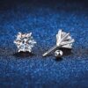 Korey Moissanite Stud Earrings with round brilliant stones in 6-prong sterling silver setting on blue background