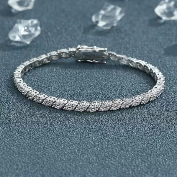 Elegant silver-toned Luna moissanite bracelet with round cut stones displayed on textured blue background